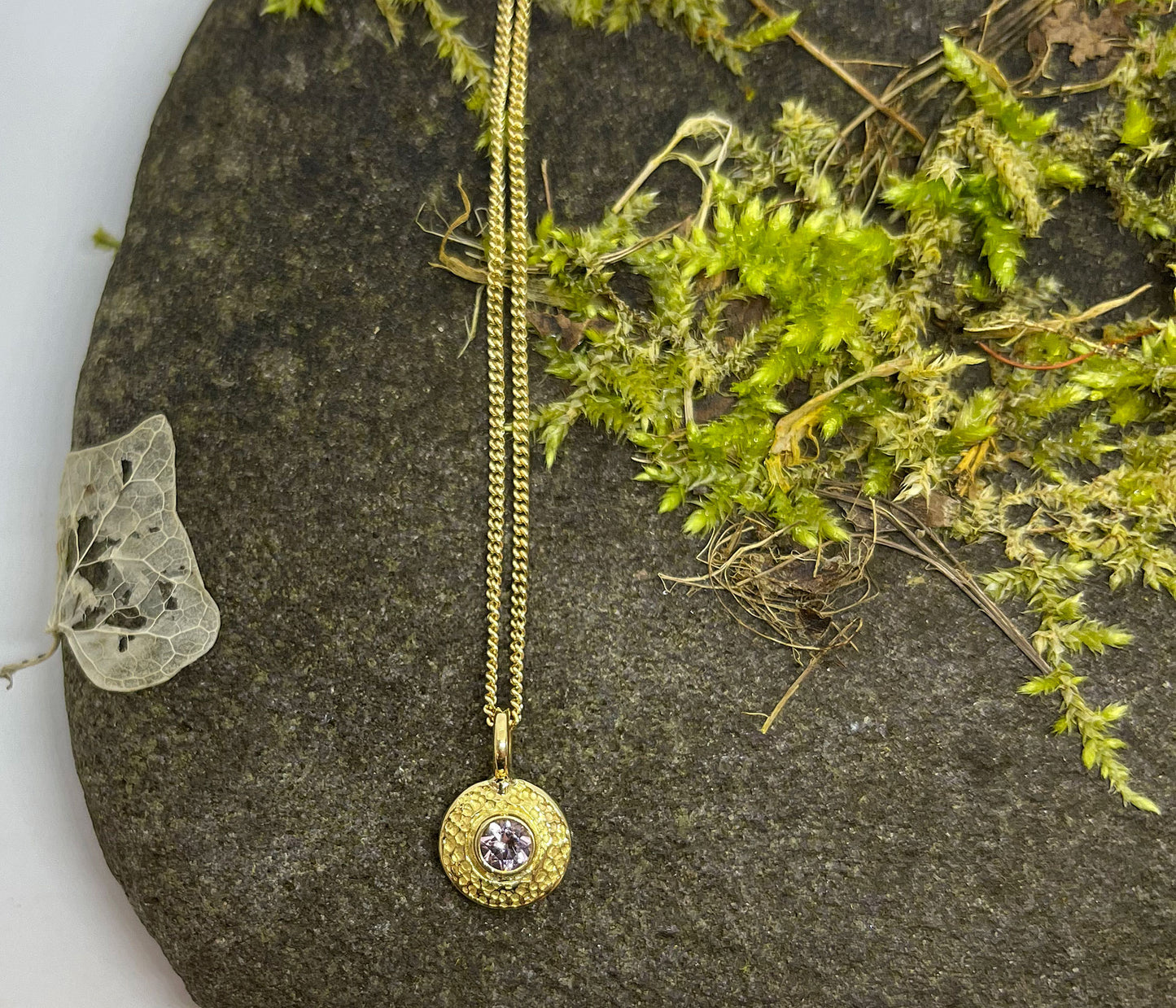 Gold disc with gem pendant