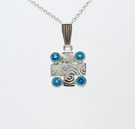 Silver cross with glass stones.