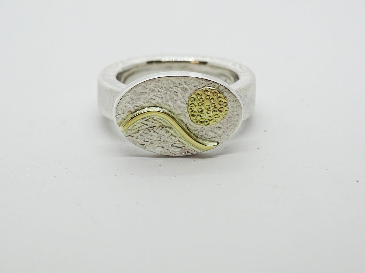 Ring. Sun and mountain.