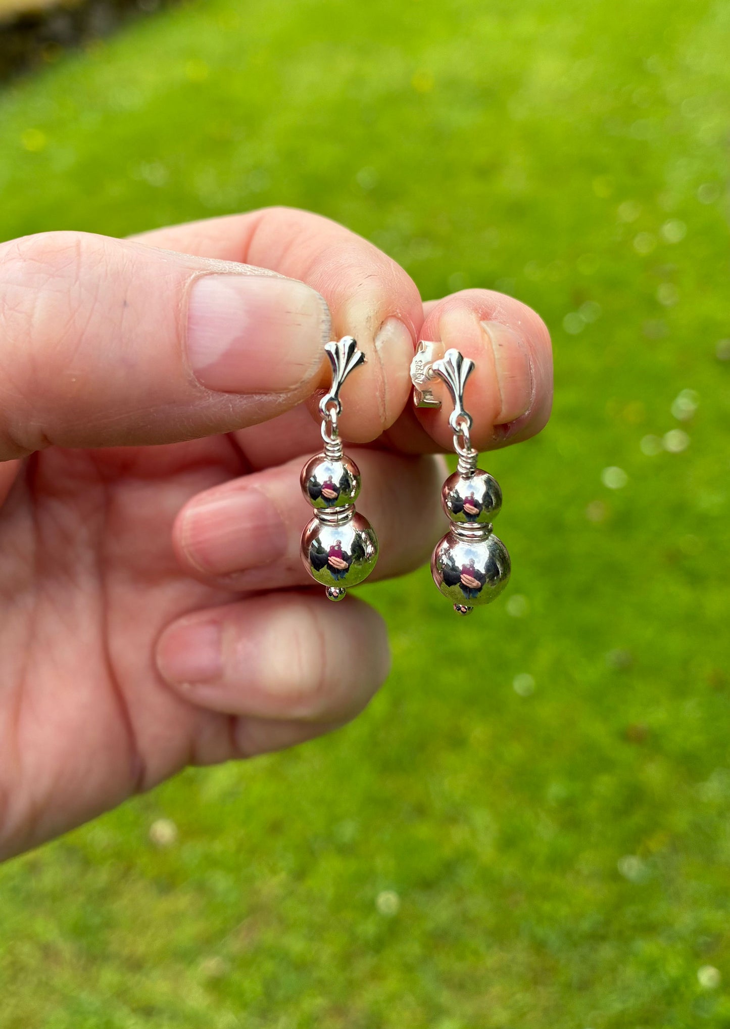 Two ball earrings.