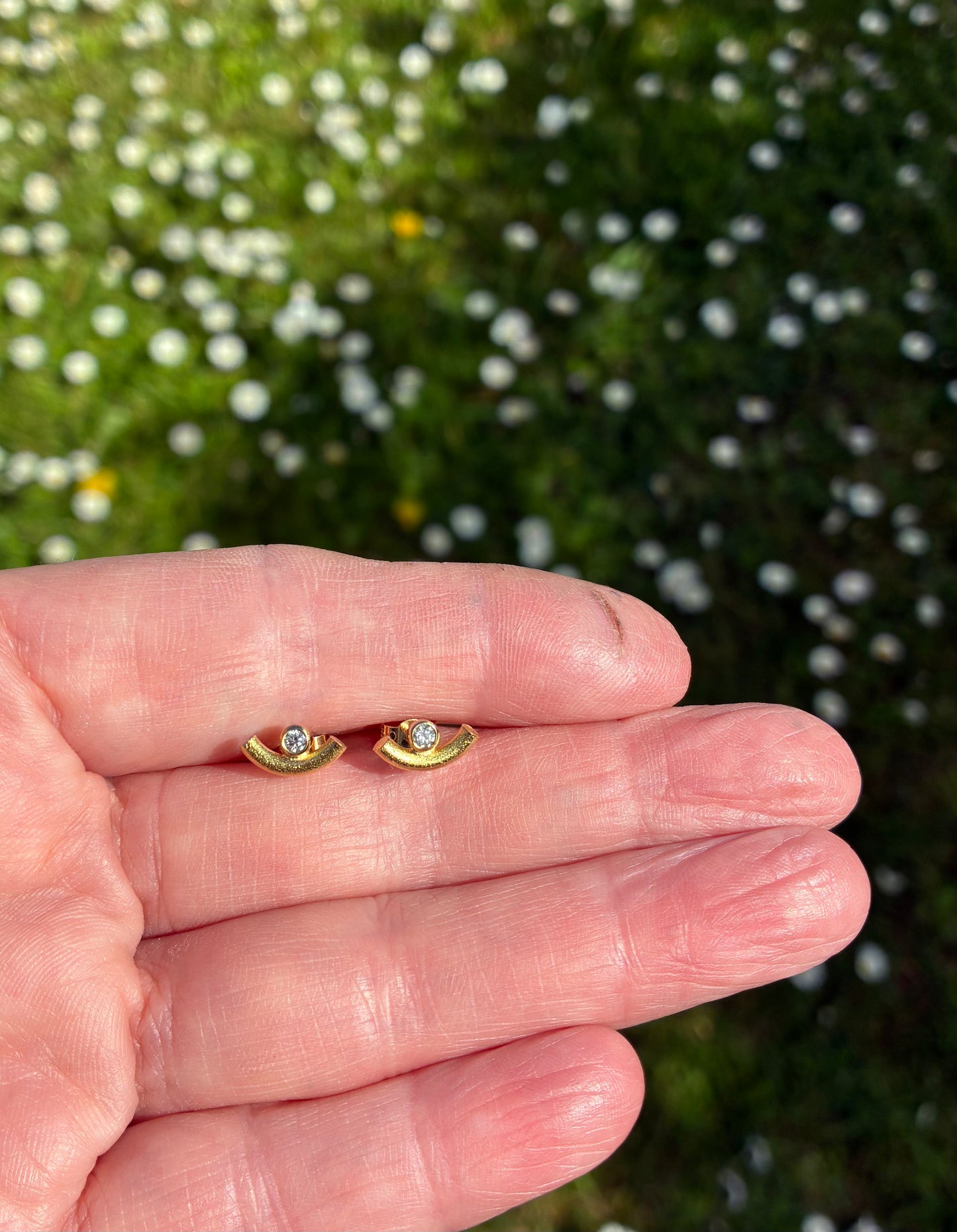 Studs. Curve and diamond.