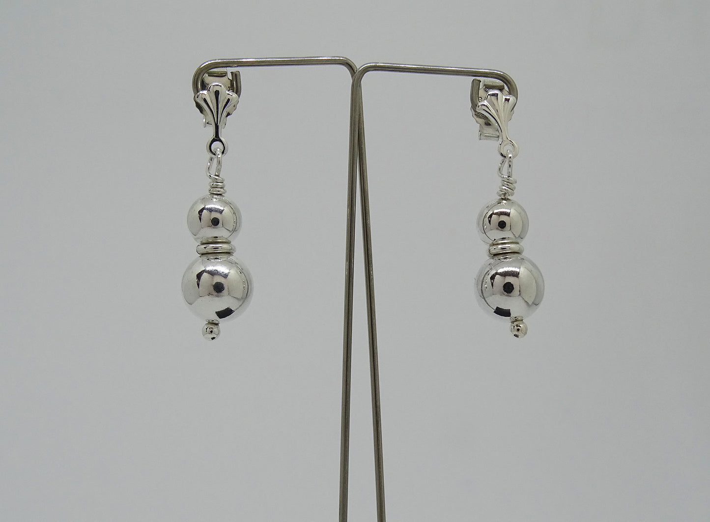 Two ball earrings.